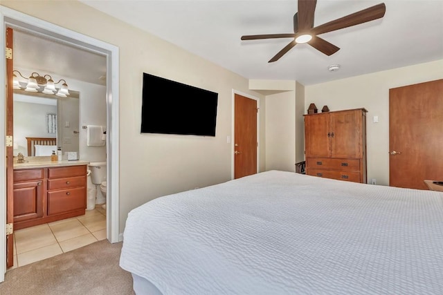 2883 Burgess Creek Rd Unit 302, Steamboat Springs, CO 80487 - bedroom featuring light colored carpet, light tile patterned flooring, ensuite bathroom, and ceiling fan