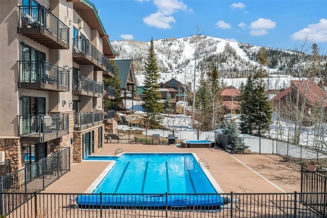 2883 Burgess Creek Rd Unit 302, Steamboat Springs, CO 80487 - snow covered pool featuring a mountain view and a community pool