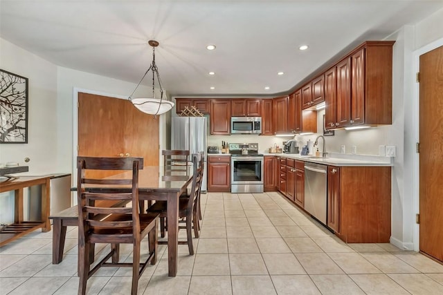 2883 Burgess Creek Rd Unit 302, Steamboat Springs, CO 80487 - kitchen featuring appliances with stainless steel finishes, light tile patterned floors, light countertops, recessed lighting, and a sink