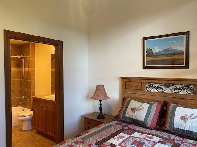 bedroom with light tile patterned flooring, ensuite bath, and a sink