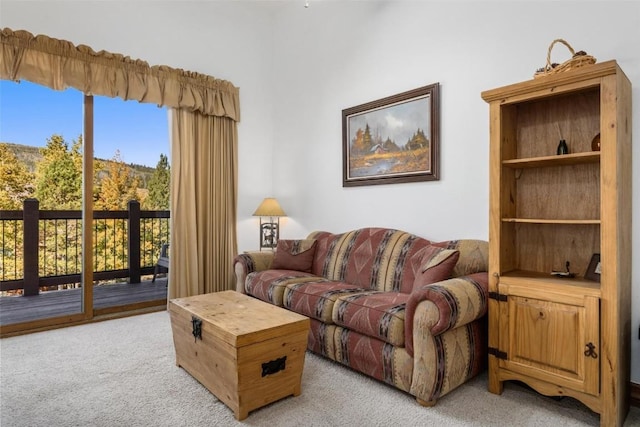 living area featuring light colored carpet and a wealth of natural light