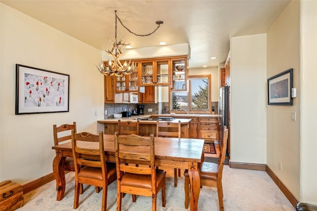 2685 Timber Ct Unit 2, Steamboat Springs, CO 80487 - dining area with a chandelier, baseboards, recessed lighting, and light colored carpet