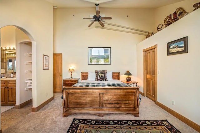 2685 Timber Ct Unit 2, Steamboat Springs, CO 80487 - bedroom featuring high vaulted ceiling, arched walkways, light colored carpet, and baseboards