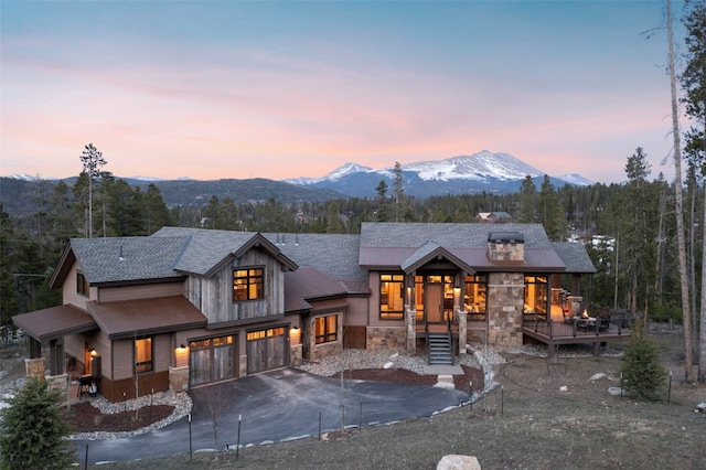 view of front facade with a mountain view and a garage