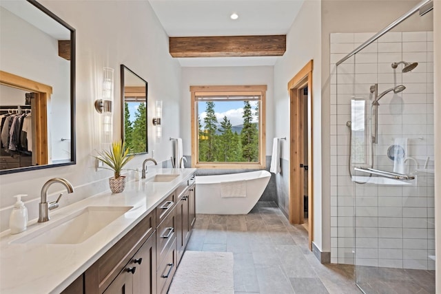 bathroom featuring beamed ceiling, vanity, and separate shower and tub