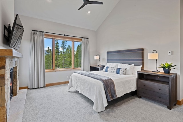 carpeted bedroom with ceiling fan and high vaulted ceiling