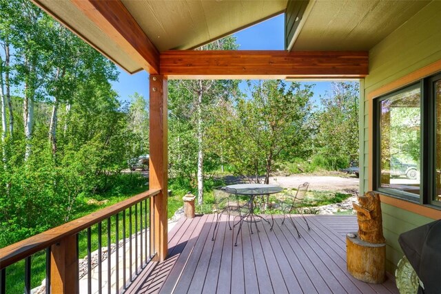 31020 Fallen Falcon Trl, Oak Creek, CO 80467 - wooden terrace with outdoor dining space and view of wooded area