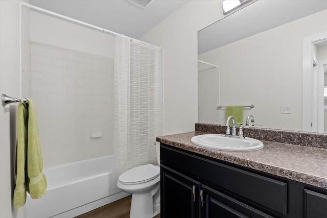 bathroom featuring toilet, vanity, shower / bath combo with shower curtain, and wood finished floors