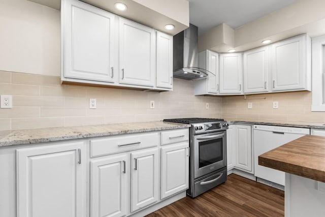 27401 Brandon Cir, Steamboat Springs, CO 80487 - kitchen with stainless steel range with gas cooktop, wall chimney exhaust hood, dishwasher, and white cabinetry