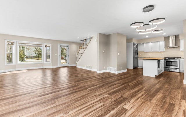 27401 Brandon Cir, Steamboat Springs, CO 80487 - unfurnished living room featuring dark wood-style flooring, baseboards, stairway, a chandelier, and recessed lighting