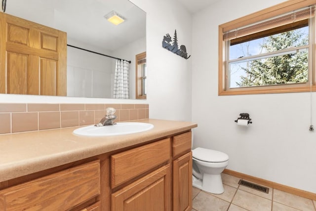 27401 Brandon Cir, Steamboat Springs, CO 80487 - bathroom with vanity, backsplash, toilet, tile patterned flooring, and a shower with shower curtain