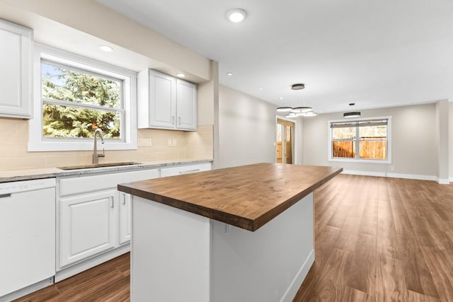 27401 Brandon Cir, Steamboat Springs, CO 80487 - kitchen featuring white dishwasher, a sink, butcher block counters, dark wood-type flooring, and backsplash