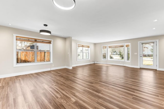 27401 Brandon Cir, Steamboat Springs, CO 80487 - unfurnished living room with wood finished floors, baseboards, and recessed lighting