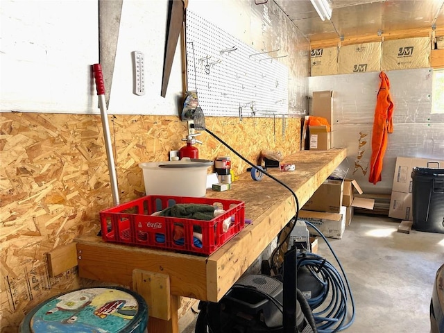 interior space featuring concrete flooring and a workshop area