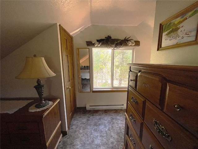 interior space with a baseboard heating unit, dark colored carpet, a textured ceiling, and lofted ceiling