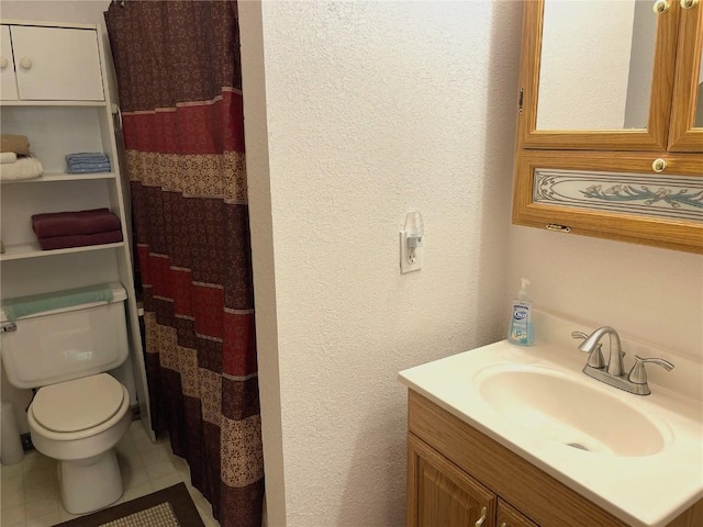 full bath featuring vanity, a shower with curtain, a textured wall, toilet, and tile patterned flooring