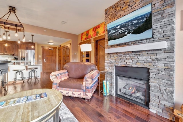 living area with hardwood / wood-style flooring and a fireplace