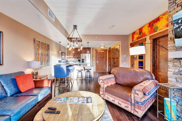 living room with visible vents and dark wood-style floors