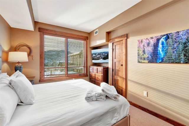 bedroom featuring carpet floors, visible vents, and baseboards