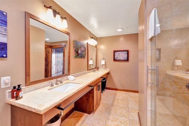 bathroom with double vanity, tile patterned floors, a stall shower, and a sink