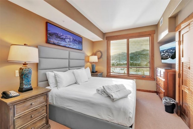 bedroom featuring light carpet, baseboards, and visible vents