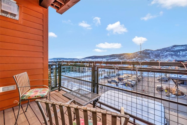 snow covered back of property with a mountain view