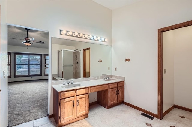 20596 E Shefield Ct, Parker, CO 80138 - bathroom with ceiling fan, a stall shower, double vanity, and tile patterned floors