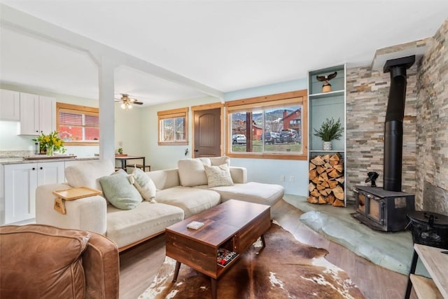 23800 County Road 16 Unit 204, Oak Creek, CO 80467 - living area featuring a wood stove, ceiling fan, and wood finished floors