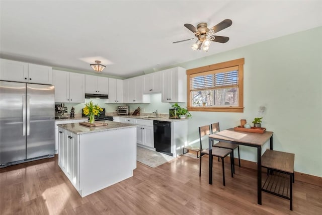 23800 County Road 16 Unit 204, Oak Creek, CO 80467 - kitchen with black appliances, white cabinets, a center island, wood finished floors, and light stone counters