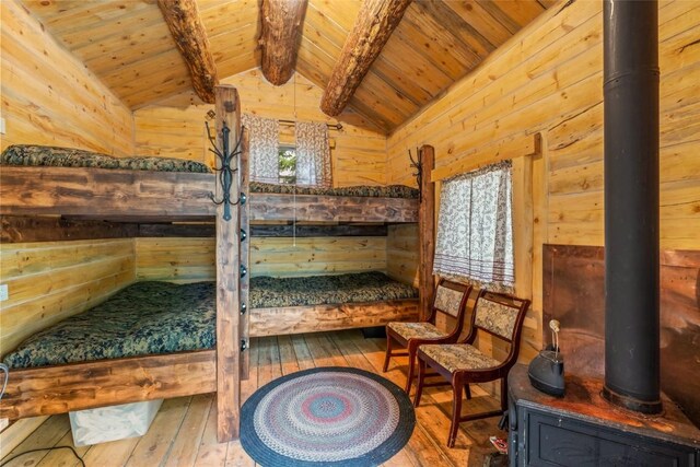 24100 Cottonwood Rd N, Clark, CO 80428 - bedroom with wooden ceiling, hardwood / wood-style flooring, wood walls, and a sauna / steam room