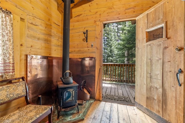 24100 Cottonwood Rd N, Clark, CO 80428 - doorway to outside with a wood stove, wood walls, and hardwood / wood-style flooring