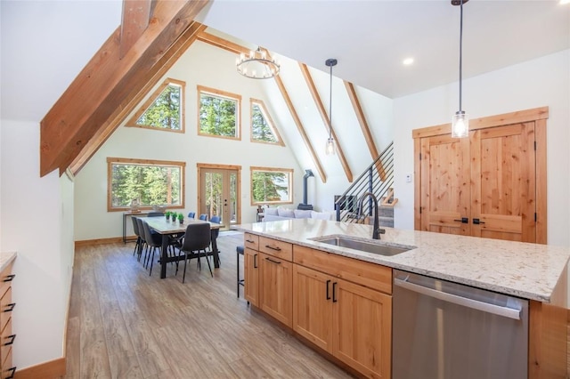 297 Robertson Ln, Breckenridge, CO 80424 - kitchen with dishwasher, light wood-type flooring, high vaulted ceiling, decorative light fixtures, and light stone counters
