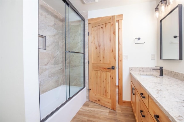 297 Robertson Ln, Breckenridge, CO 80424 - full bath with vanity, wood finished floors, and shower / bath combination with glass door