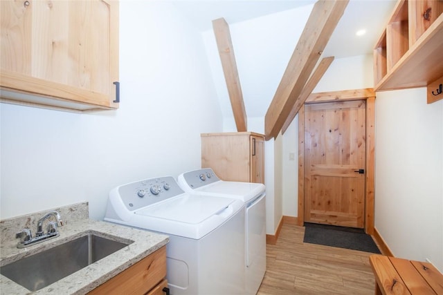 297 Robertson Ln, Breckenridge, CO 80424 - washroom featuring washer and dryer, cabinet space, and light wood-type flooring