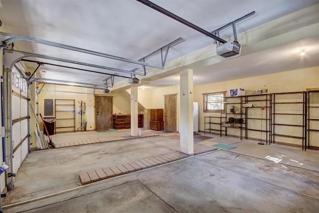 garage featuring electric panel and a garage door opener