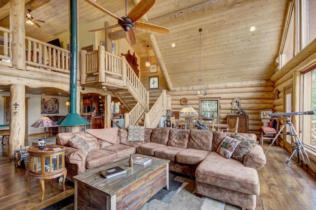 living area featuring high vaulted ceiling, wooden ceiling, a wood stove, and wood-type flooring