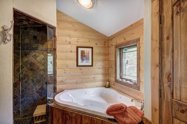 full bath featuring lofted ceiling, a whirlpool tub, wood walls, and a shower stall