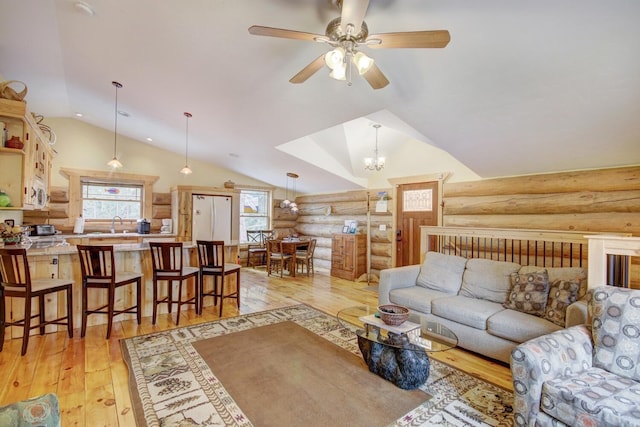 living room with lofted ceiling, log walls, light wood finished floors, and a ceiling fan