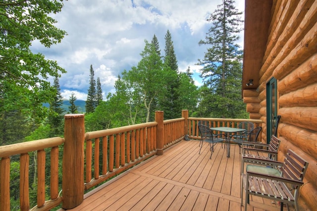 wooden terrace with outdoor dining area