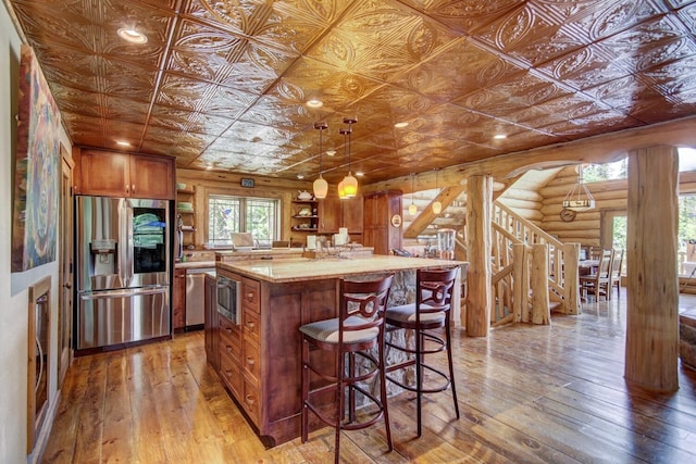 kitchen featuring an ornate ceiling, open shelves, light wood-type flooring, appliances with stainless steel finishes, and log walls