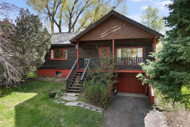 820 Yahmonite St, Steamboat Springs, CO 80487 - view of front of home with driveway, an attached garage, a front lawn, and stairway