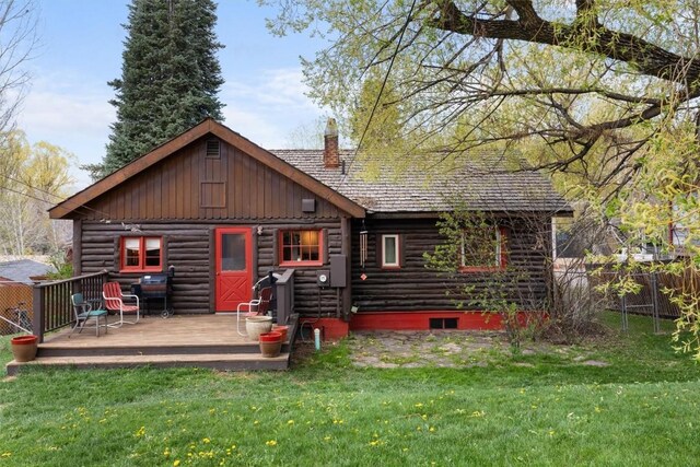820 Yahmonite St, Steamboat Springs, CO 80487 - rear view of property featuring log exterior, a wooden deck, a chimney, and board and batten siding