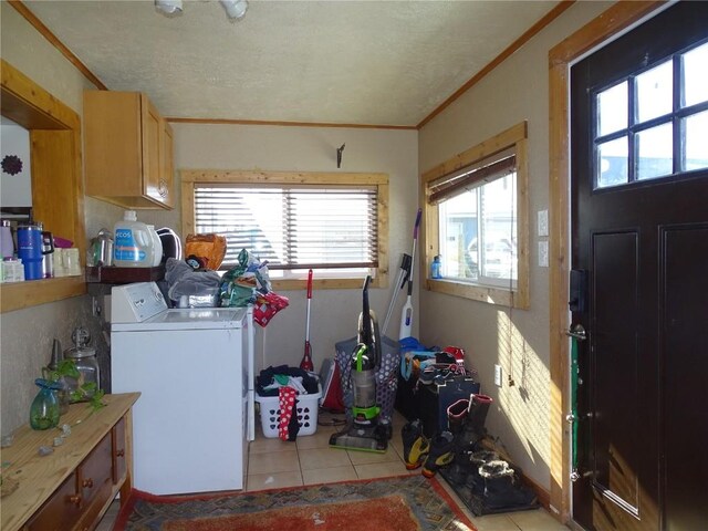 781 Hathaway St, Fairplay, CO 80440 - laundry room featuring washer and clothes dryer, cabinet space, light tile patterned floors, crown molding, and a textured ceiling