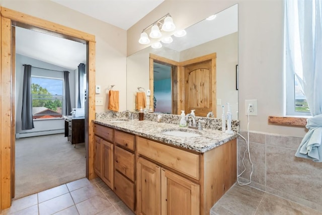 336 Starlite Ln, Hayden, CO 81639 - bathroom featuring double vanity, tile patterned flooring, baseboard heating, and vaulted ceiling