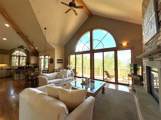 368 Black Hawk Cir, Silverthorne, CO 80498 - living area with beamed ceiling, a ceiling fan, wood-type flooring, a stone fireplace, and high vaulted ceiling