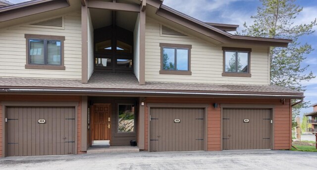 1720 Ranch Rd Unit 301, Steamboat Springs, CO 80487 - view of front of property featuring an attached garage, driveway, and a shingled roof