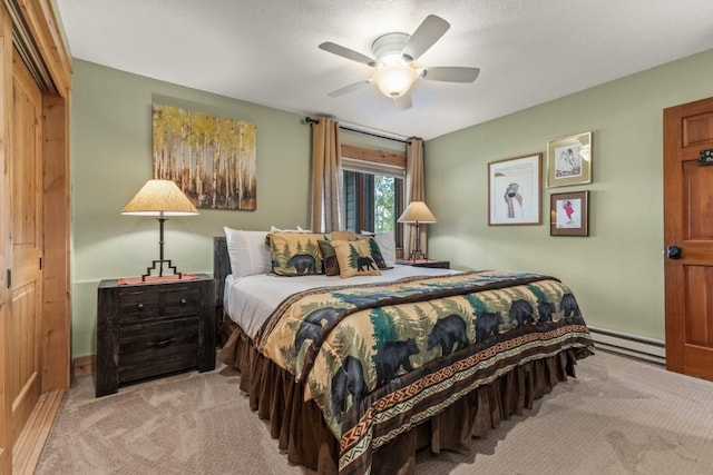 1720 Ranch Rd Unit 301, Steamboat Springs, CO 80487 - bedroom with baseboard heating, carpet, baseboards, and a ceiling fan