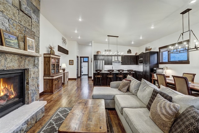 53 Hargrove Way, Silverthorne, CO 80498 - living area with dark wood-style flooring, a chandelier, a stone fireplace, and recessed lighting