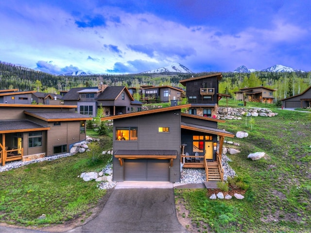 53 Hargrove Way, Silverthorne, CO 80498 - contemporary house with a mountain view, driveway, an attached garage, a residential view, and a front yard