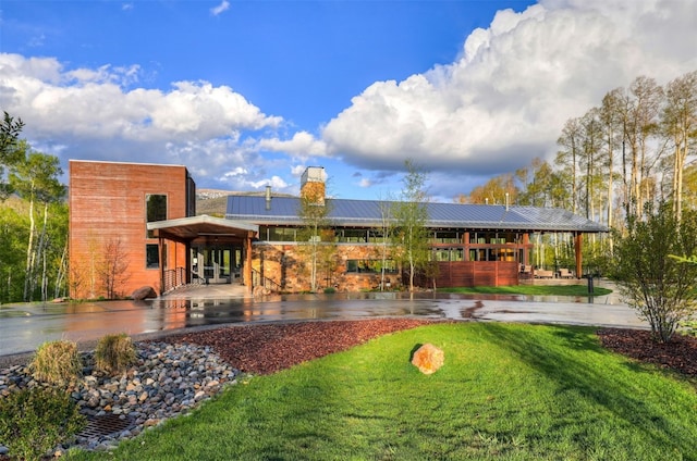 53 Hargrove Way, Silverthorne, CO 80498 - back of house with a chimney, a yard, metal roof, and a standing seam roof